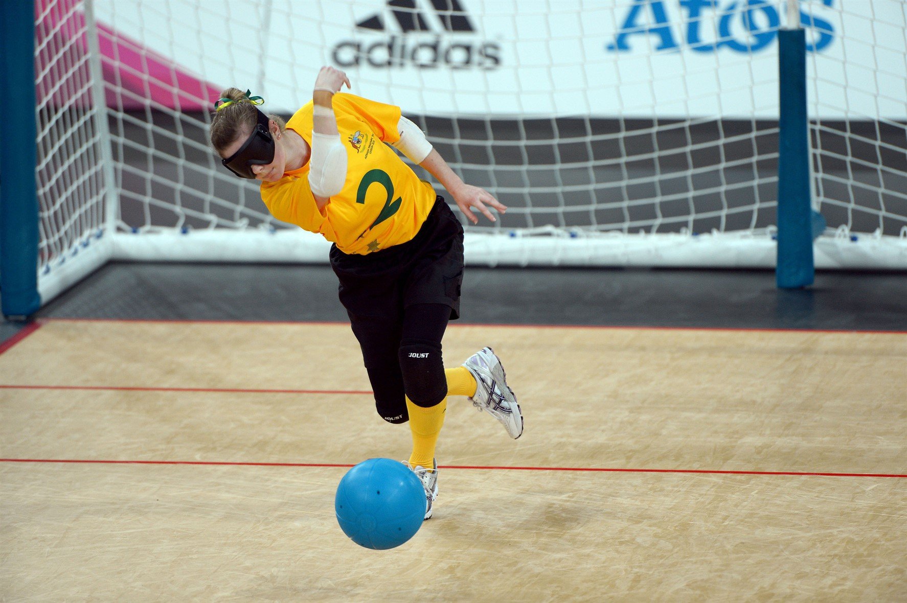 Goalball athlete rolling the ball.