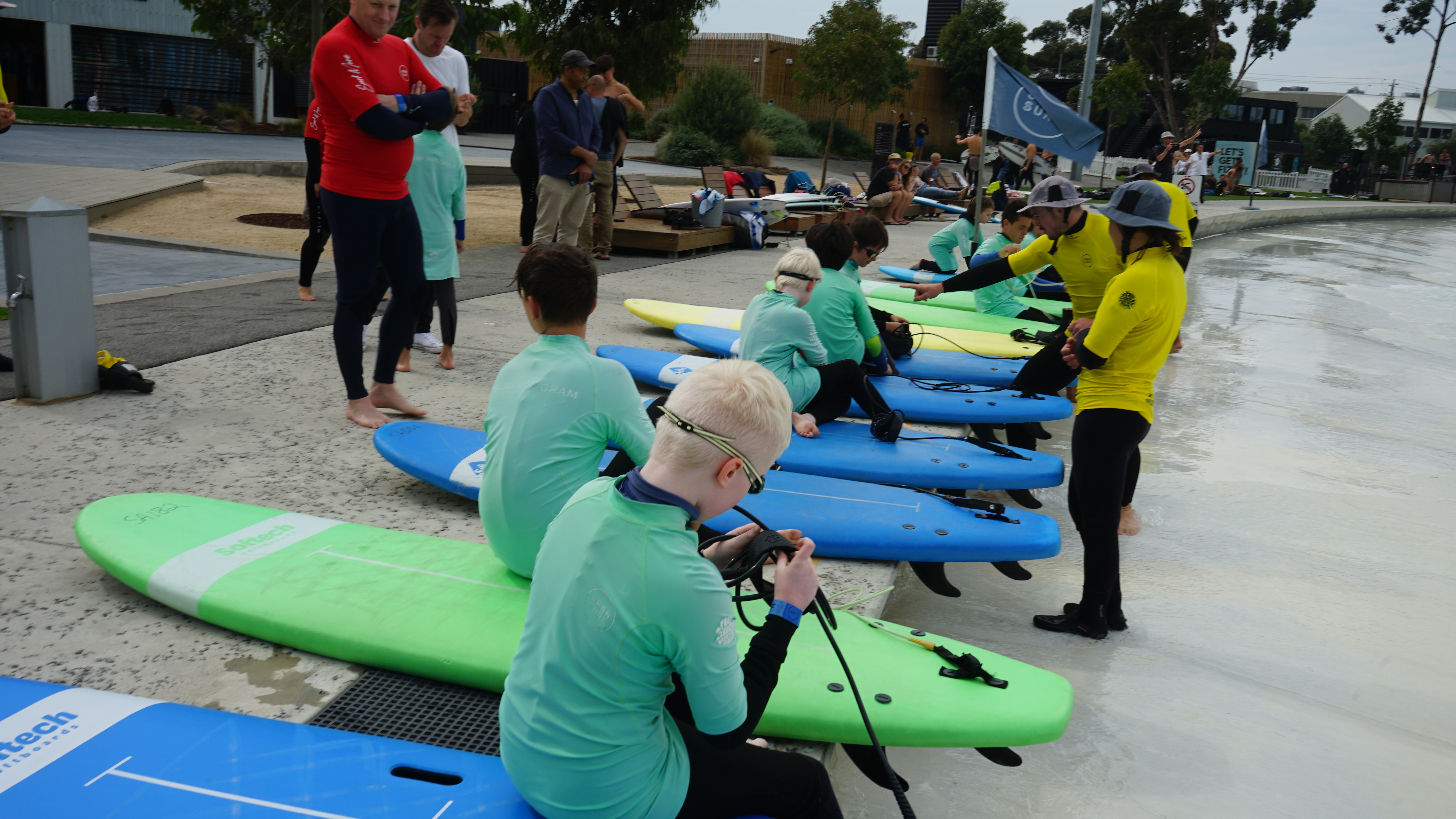 The group getting ready on their surfboards. 