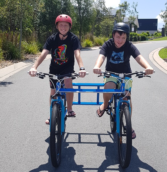 Kai and his brother sitting on their tandem bike