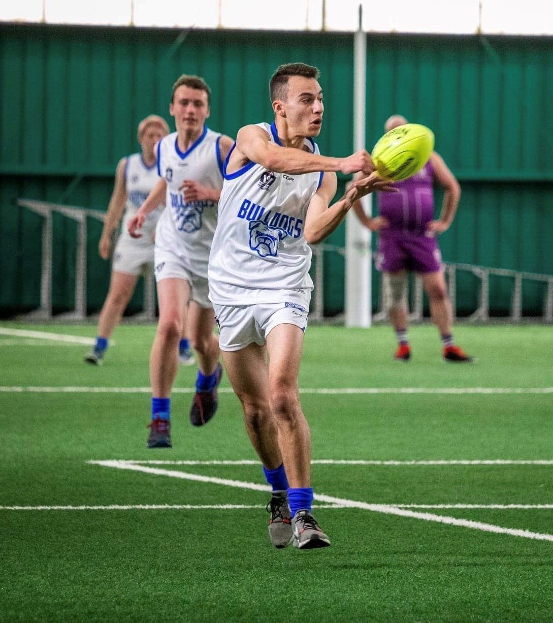 "Steve handballing a football during a VFL match"