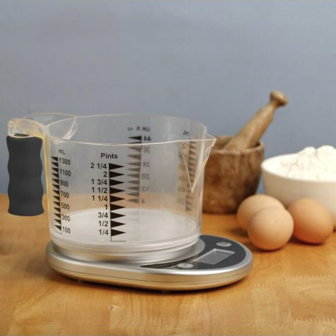 Clear measuring jug sitting on scales on a kitchen bench